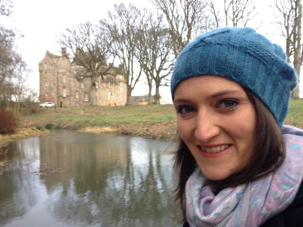 Image of Kellie Barnes smiling in front of a historical building